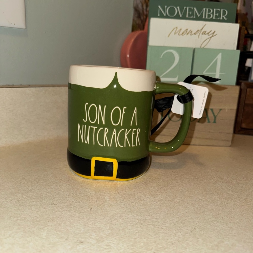 Rae dunn son of a nutcracker mug elf movie